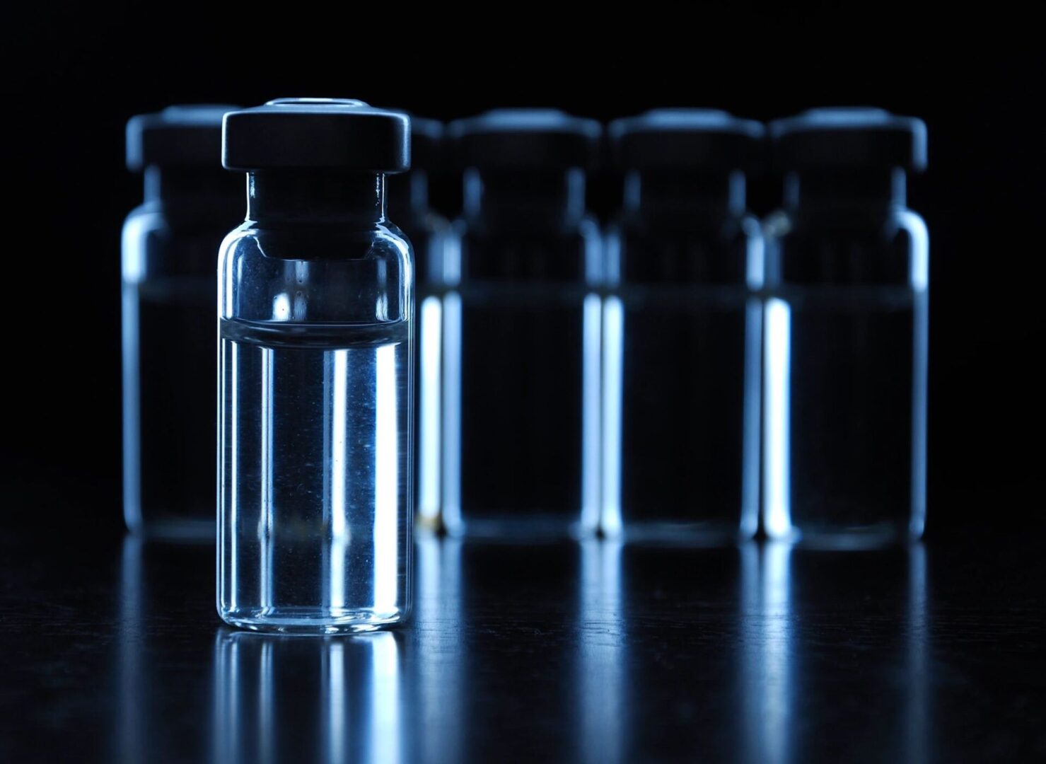 A group of small glass bottles sitting on top of a table.