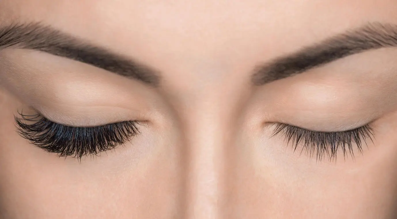 A close up of the eyes with long eyelashes