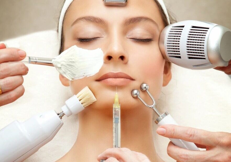 A woman getting her face waxed by several hands.